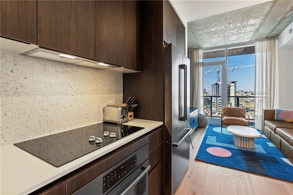 48 East Avenue, Unit 1503 Austin, TX 78701 - Photo 6 of 40 a room with furniture and wooden floor