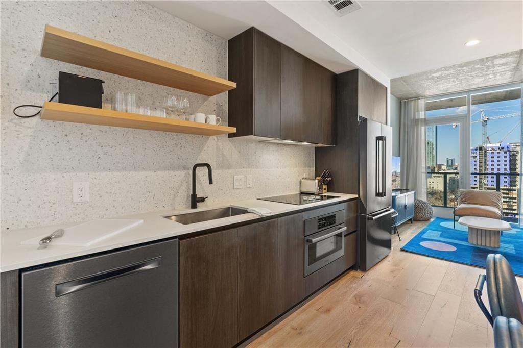 48 East Avenue, Unit 1503 Austin, TX 78701 - Photo 8 of 40 a kitchen with stainless steel appliances a sink stove and cabinets