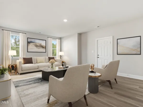 a living room with furniture a flat screen tv and a window