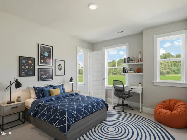 a bedroom with a bed a desk and chair