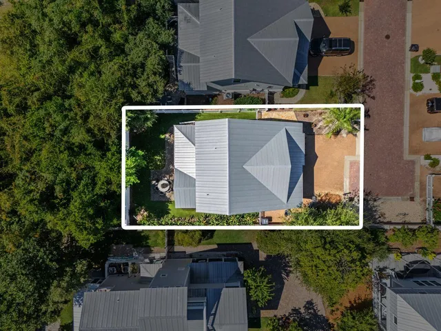 an aerial view of a house with a yard and outdoor seating