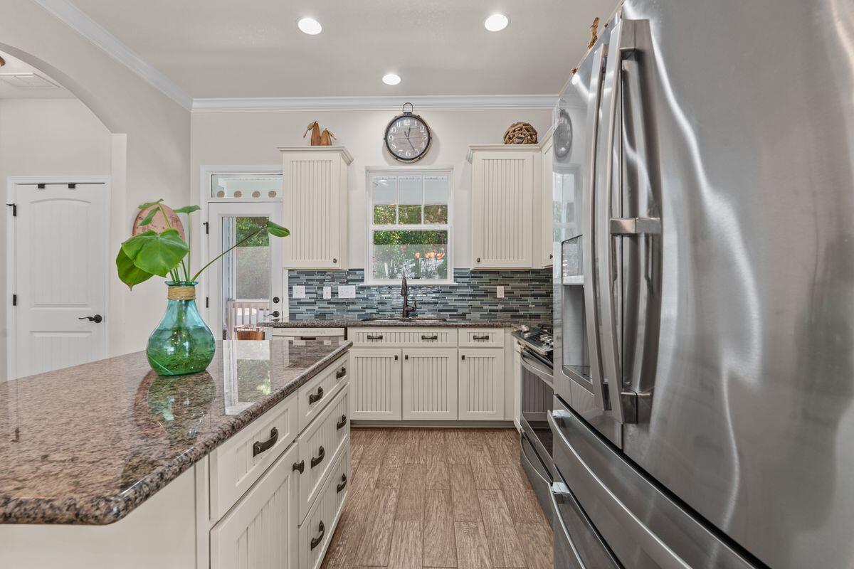 38 Inlet Cove Inlet Beach, FL 32461 - Photo 9 of 29 a kitchen with stainless steel appliances granite countertop a refrigerator a sink and wooden floors