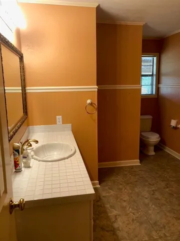 a bathroom with a sink and toilet