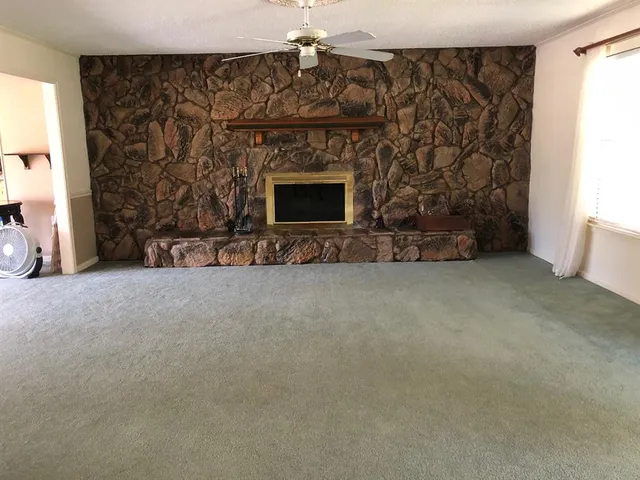a view of an empty room with a fireplace