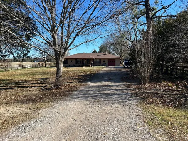 a view of a yard with large trees
