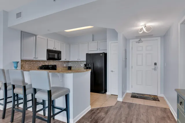 a living room with furniture a rug and a painting on the wall