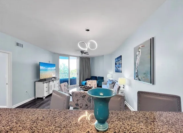 a kitchen with granite countertop white cabinets and a stove