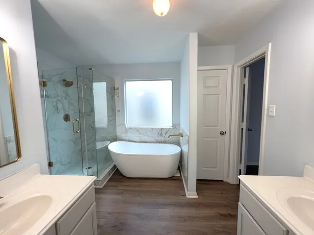 a spacious bathroom with a sink and a large mirror