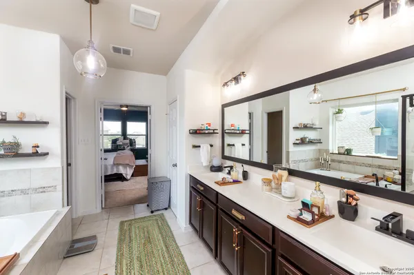 a large kitchen with kitchen island a large counter space a sink stainless steel appliances and cabinets