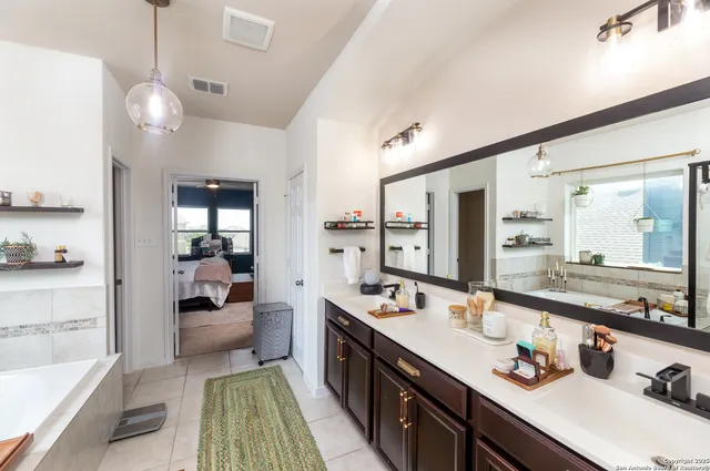 a large kitchen with kitchen island a large counter space a sink stainless steel appliances and cabinets