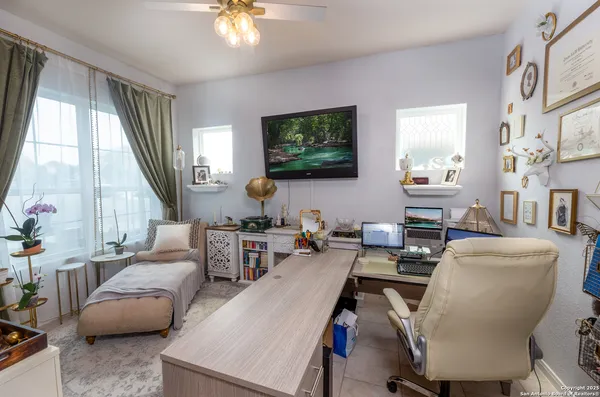 a living room with furniture a large window and a flat screen tv
