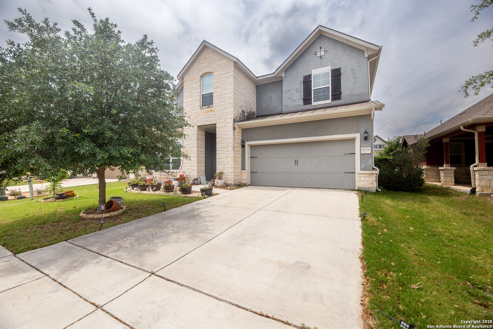8701 Stackstone Schertz, TX 78154 - Photo 24 of 25 a front view of a house with a yard and garage