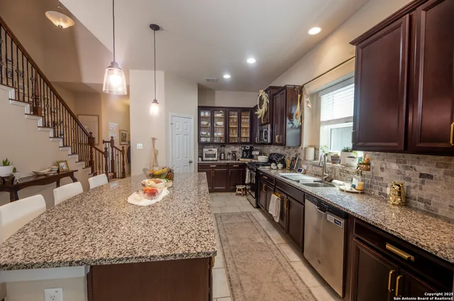 a kitchen with sink stove and cabinets