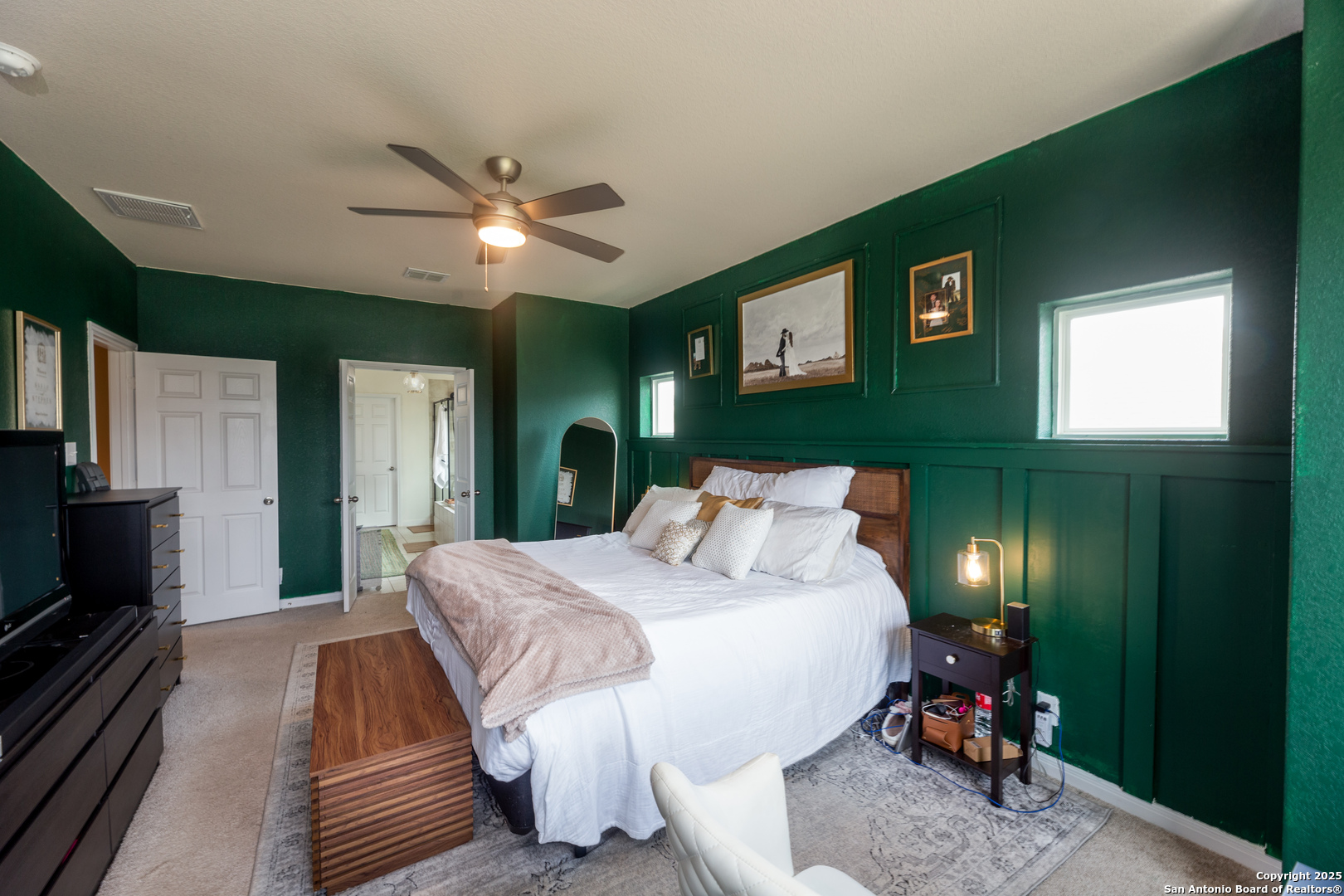 8701 Stackstone Schertz, TX 78154 - Photo 9 of 25 a bedroom with a bed and a chandelier