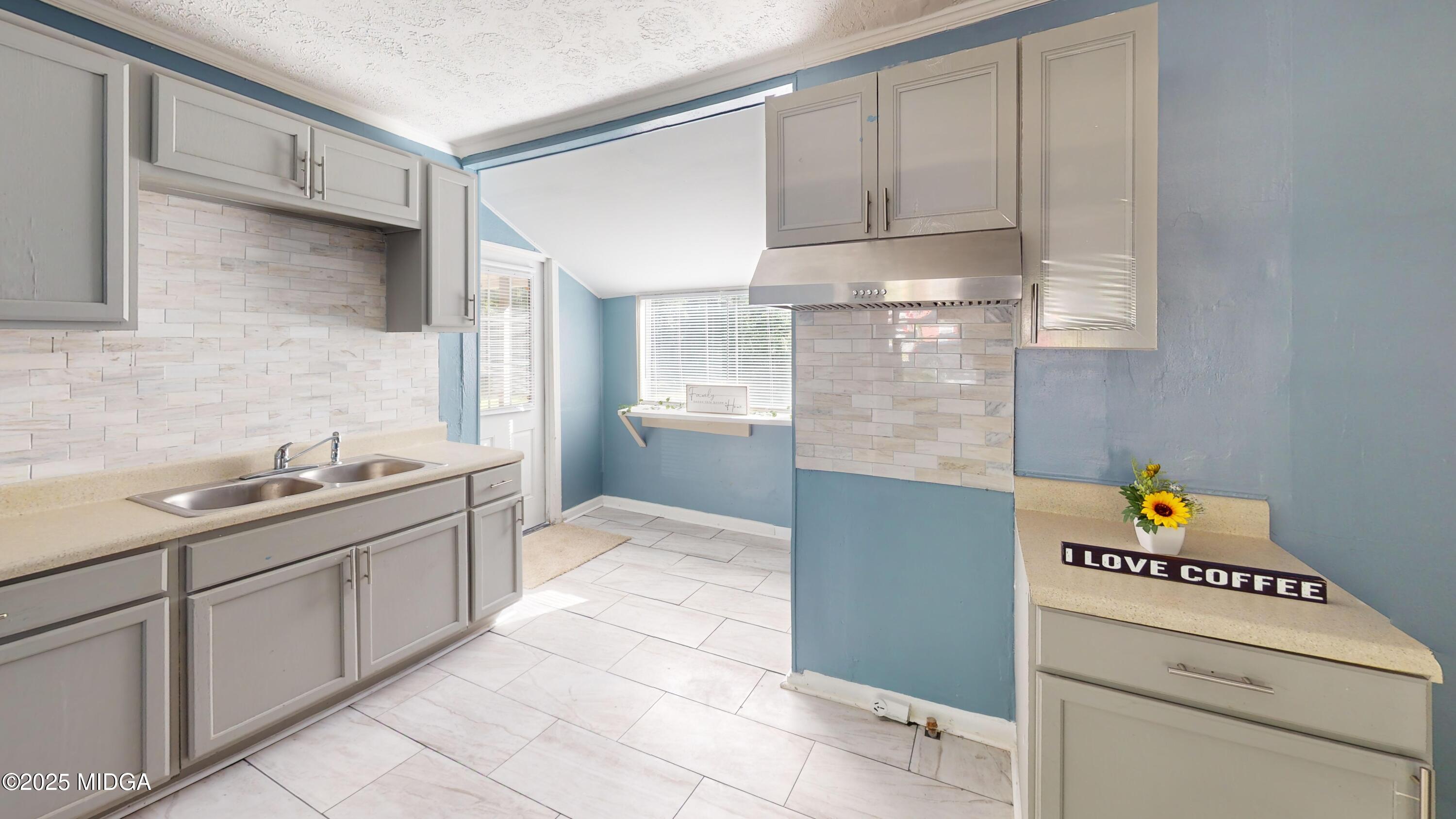 3979 Spencer Circle Macon, GA 31206 - Photo 3 of 14 a kitchen with a sink and cabinets