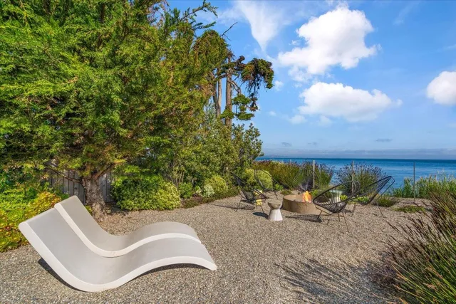a backyard of a house with table and chairs
