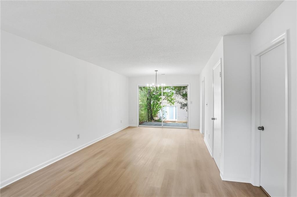 413 Promenade Court Marietta, GA 30064 - Photo 4 of 28 a view of an empty room with wooden floor and a window