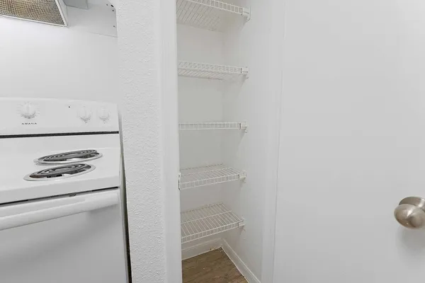 an empty room with a window and a ceiling fan