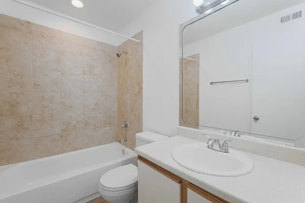 a bathroom with a sink a toilet and mirror