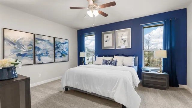 a living room with furniture kitchen view and a chandelier