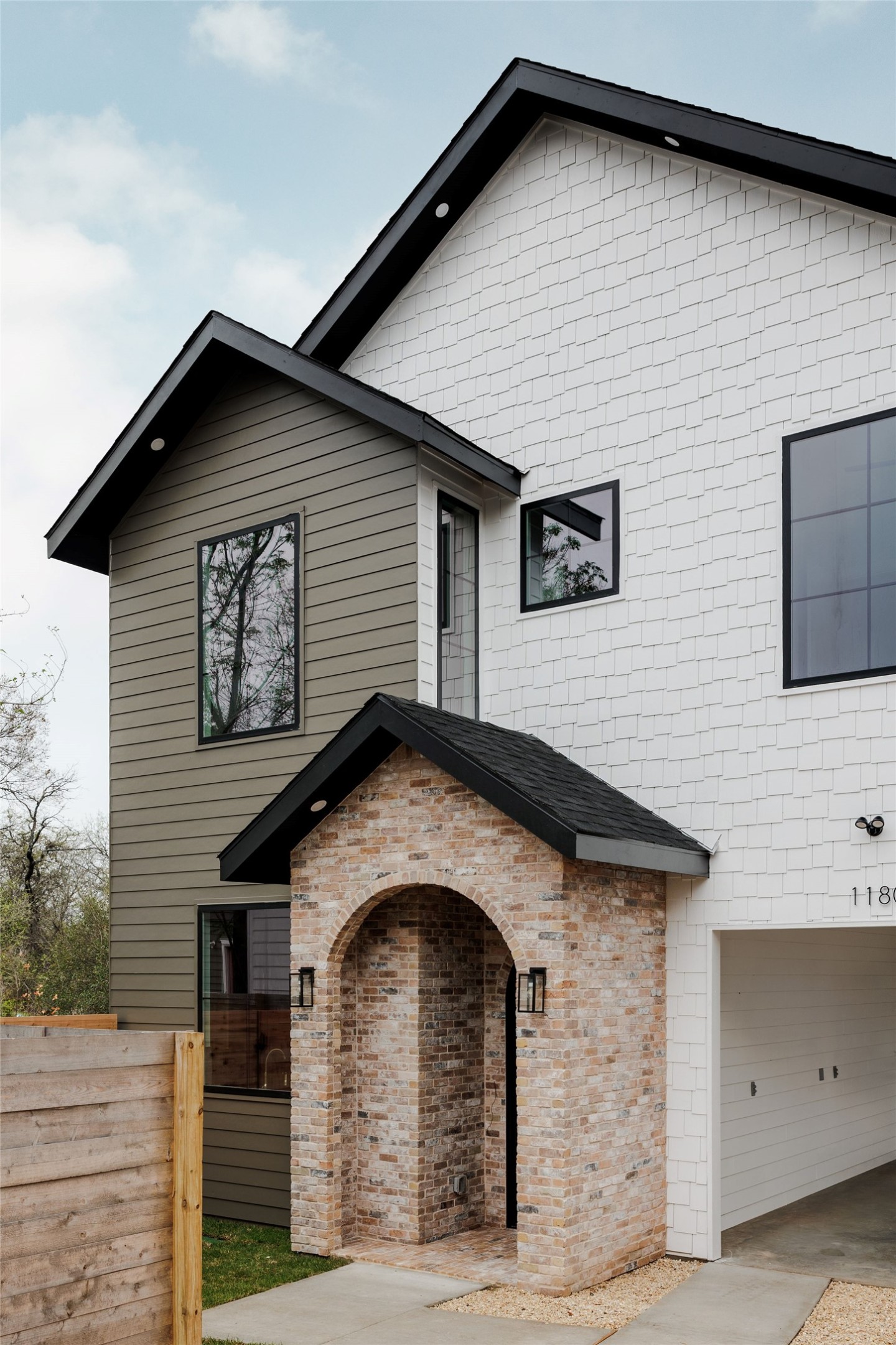 1180 Ridgeway Drive, Unit 2 Austin, TX 78702 - Photo 5 of 40 View of front facade featuring brick siding and a shingled roof