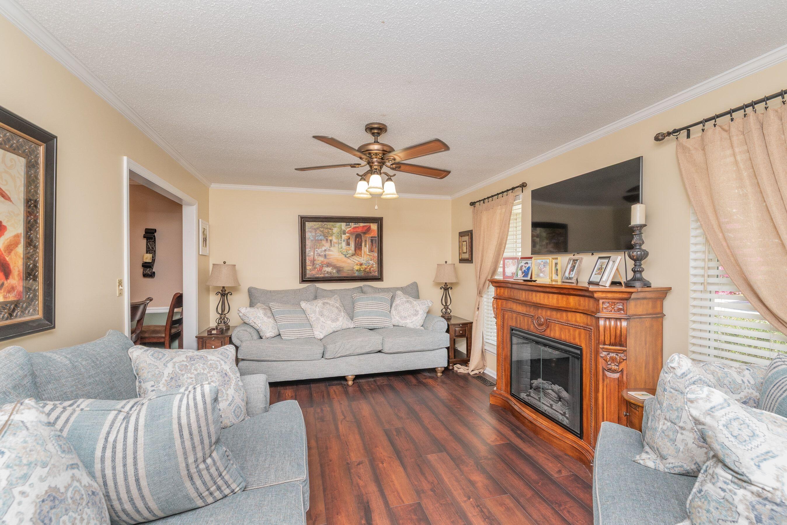 1117 Ridgemont Drive Aiken, SC 29803 - Photo 6 of 49 a living room with furniture a fireplace and a flat screen tv