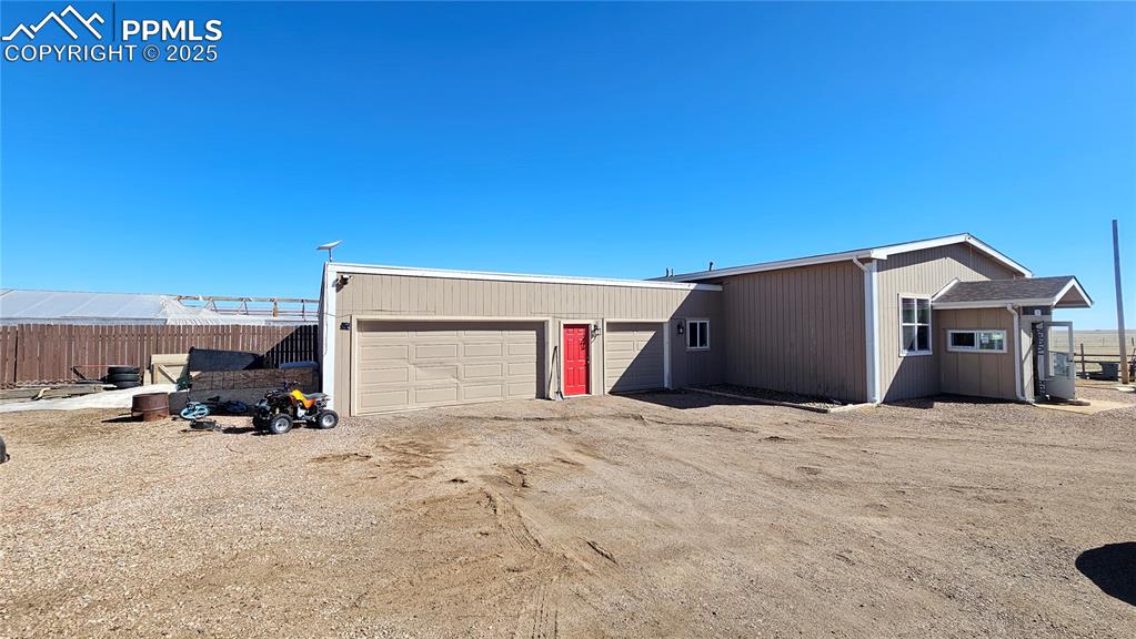 3835 Sengbeil Road Yoder, CO 80864 - Photo 3 of 48 View of front facade featuring a garage, driveway, and fence