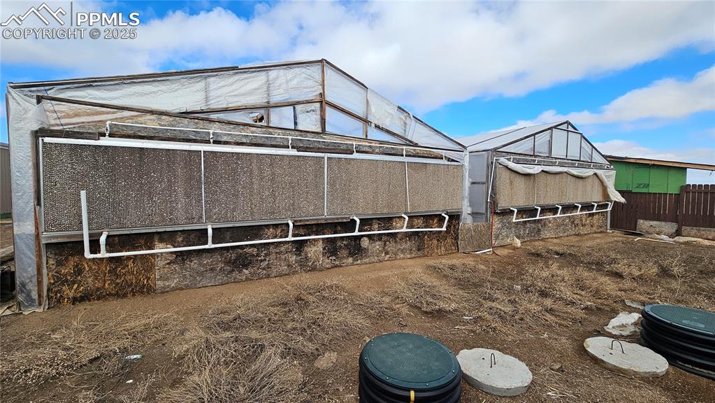 3835 Sengbeil Road Yoder, CO 80864 - Photo 40 of 48 Back of house featuring an outbuilding and fence