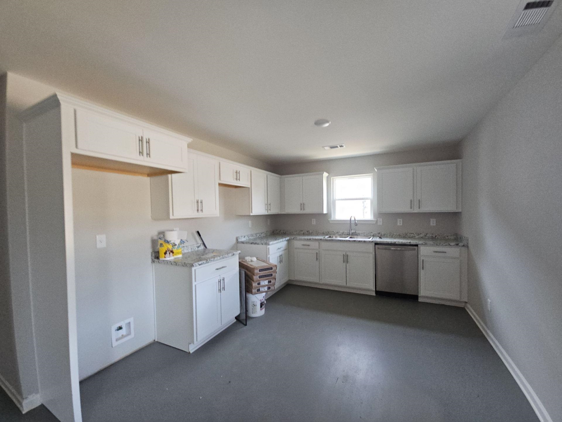 697 Granada Road Memphis, TN 38109 - Photo 3 of 7 a kitchen that has a lot of cabinets in it and wooden floors