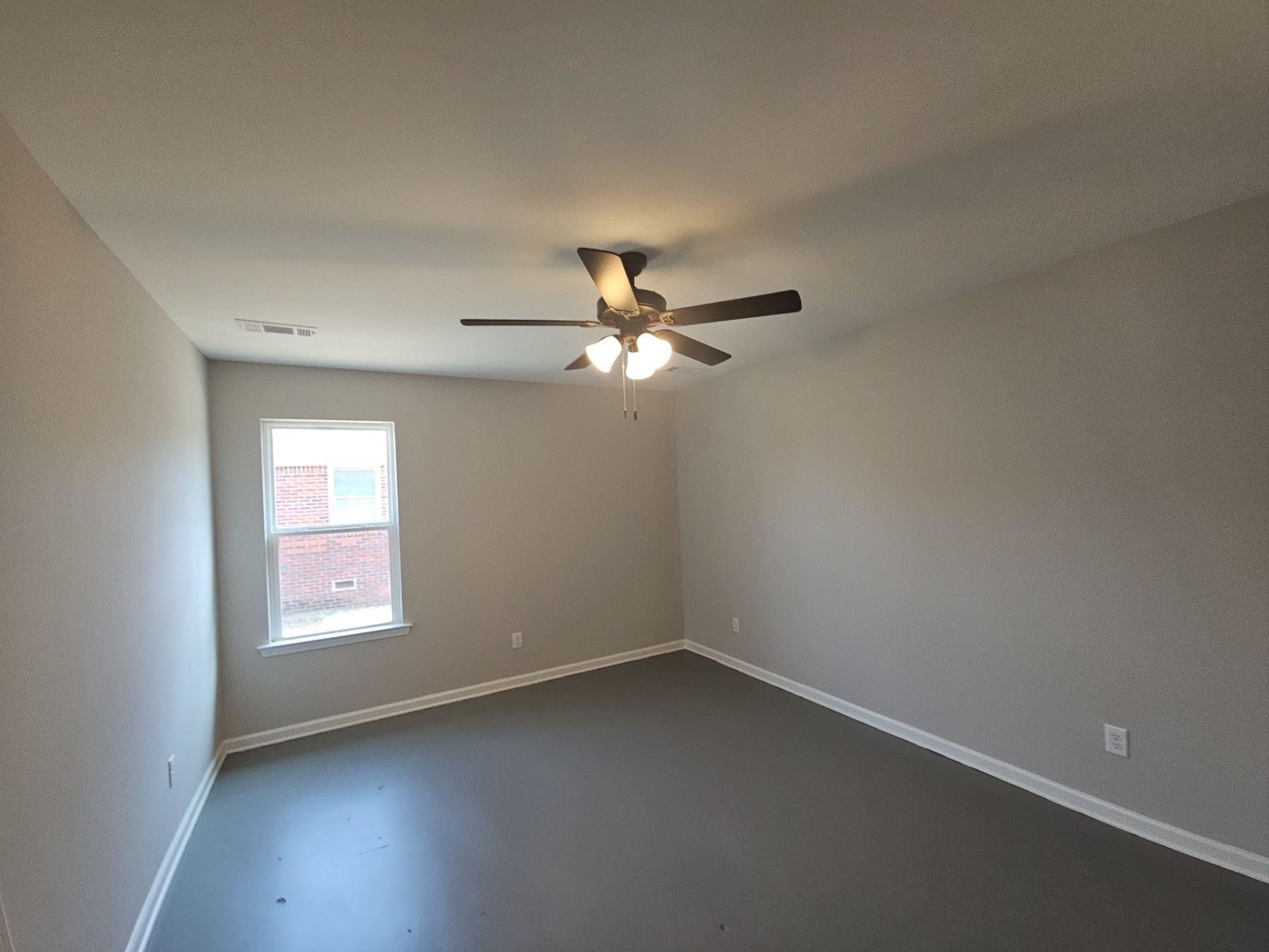 697 Granada Road Memphis, TN 38109 - Photo 5 of 7 an empty room with a window and a fan