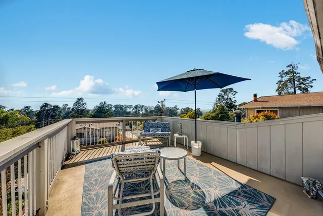 a view of a chairs and table in the balcony