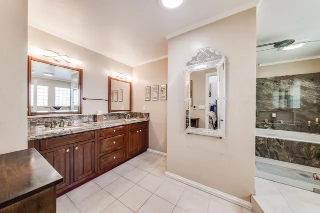 a large bathroom with a double vanity sink and a mirror