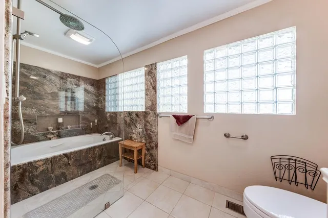 a spacious bathroom with a large tub and shower
