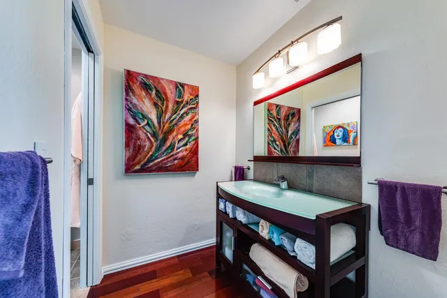 a view of a room with furniture and wooden floor