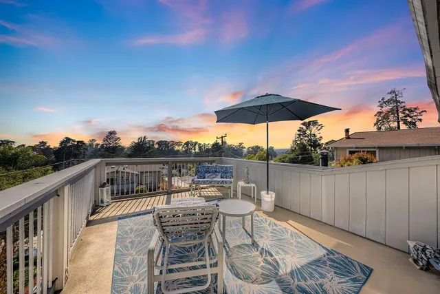a view of a roof deck with furniture