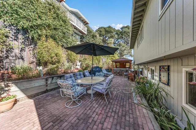a view of a patio with chairs and potted plants
