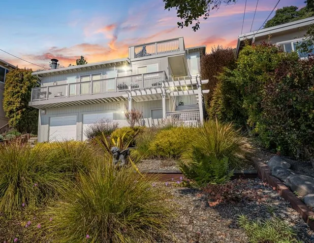 a front view of a building with a garden