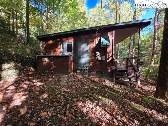 a view of a wooden house with a yard