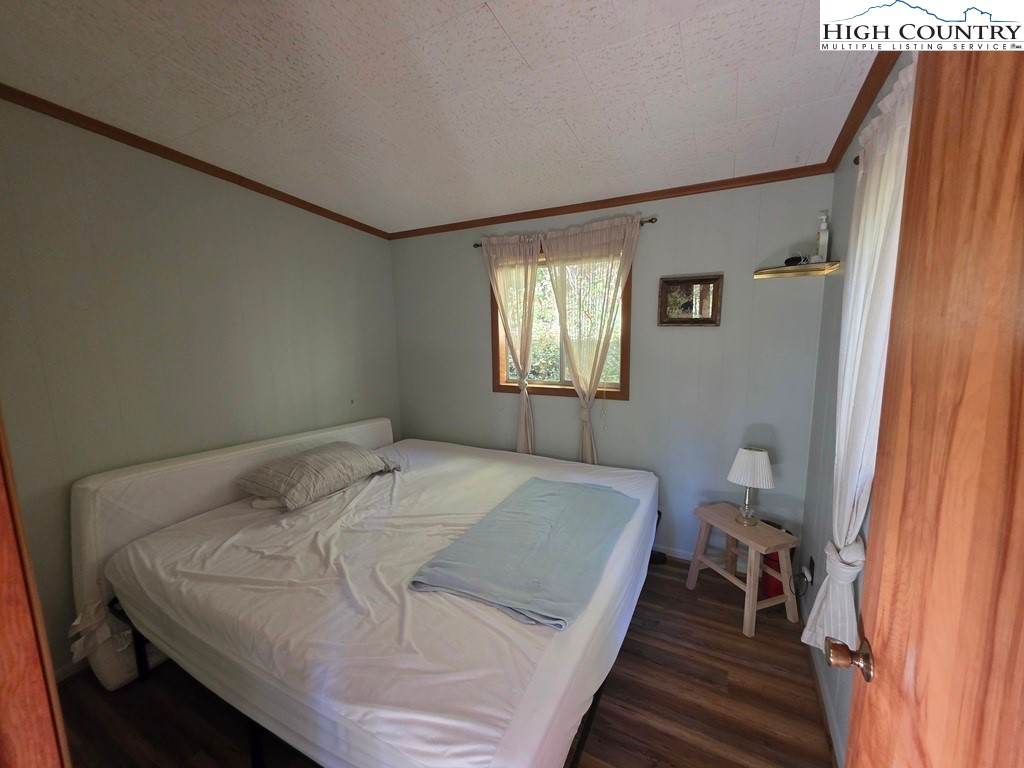 4091 Big Ivy Road Purlear, NC 28665 - Photo 19 of 40 a bedroom with a bed and a window