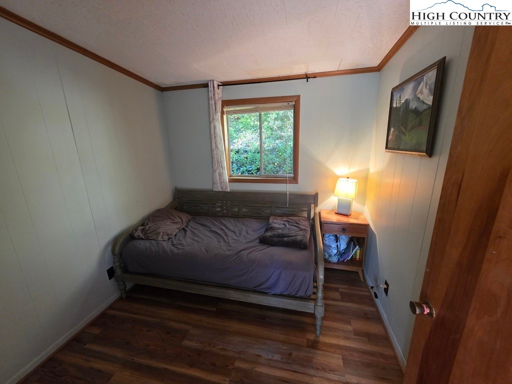 4091 Big Ivy Road Purlear, NC 28665 - Photo 20 of 40 a bedroom with a bed and a tv on table