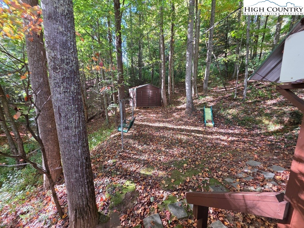 4091 Big Ivy Road Purlear, NC 28665 - Photo 9 of 40 a backyard of a house with lots of green space