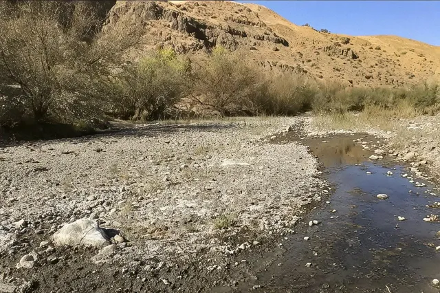 a view of a road with mountains in the background