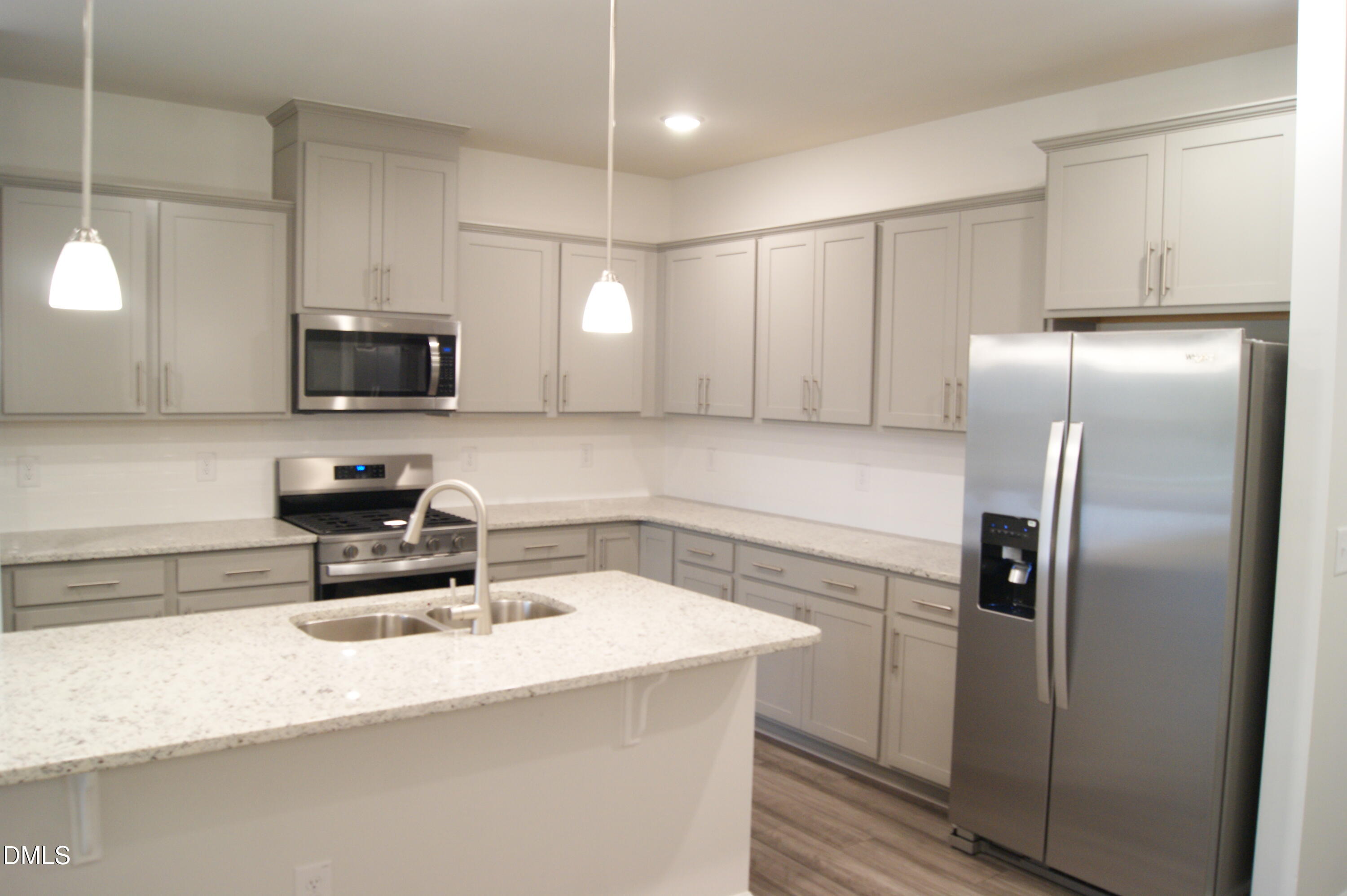 295 Glenmore Gardens Road Raleigh, NC 27603 - Photo 6 of 30 a kitchen with a refrigerator a sink a stove and microwave