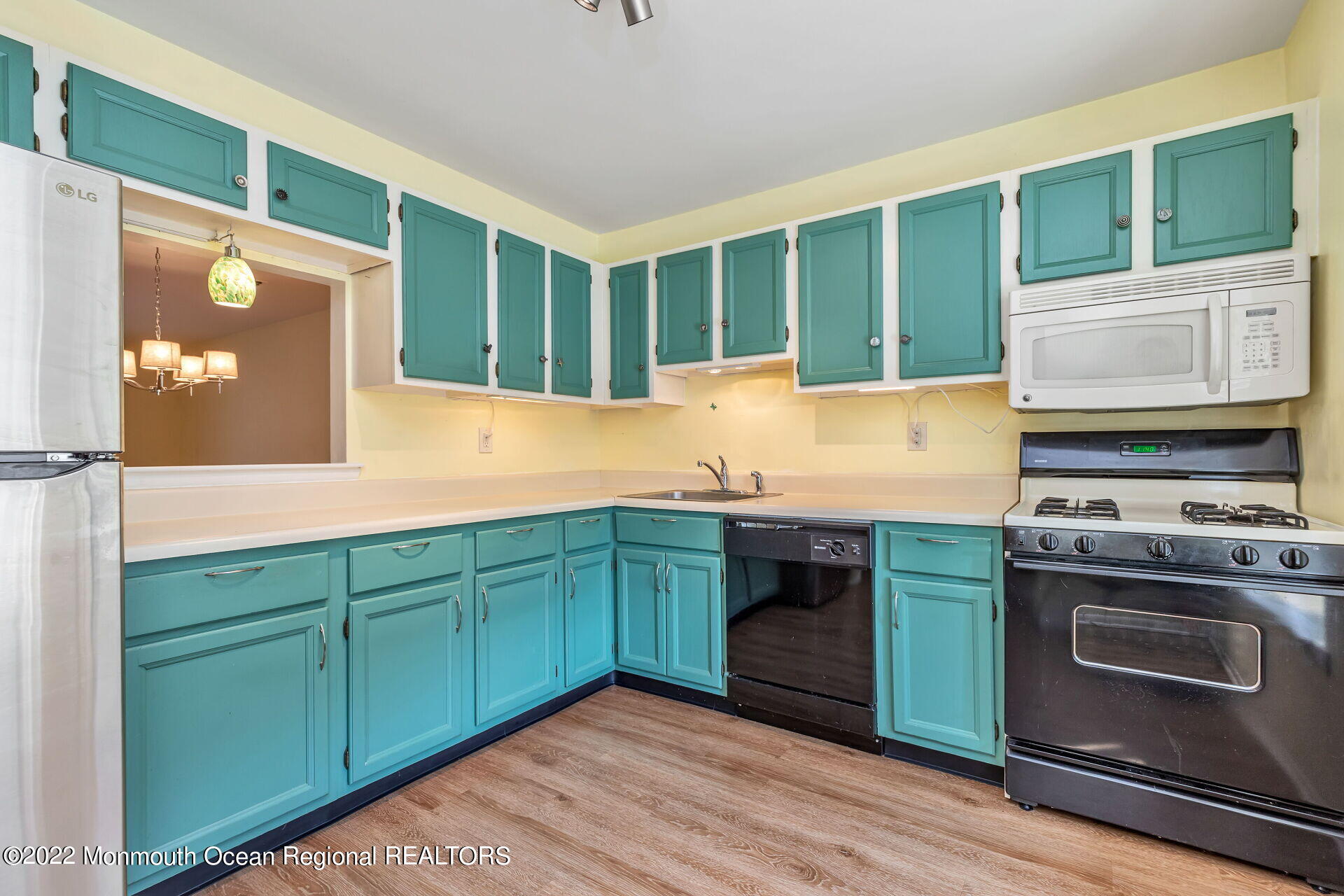 65 County Road, Unit L 70 Cliffwood, NJ 07721 - Photo 3 of 31 a kitchen with wooden cabinets and a stove top oven