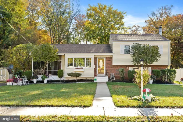 a front view of a house with a yard table and chairs