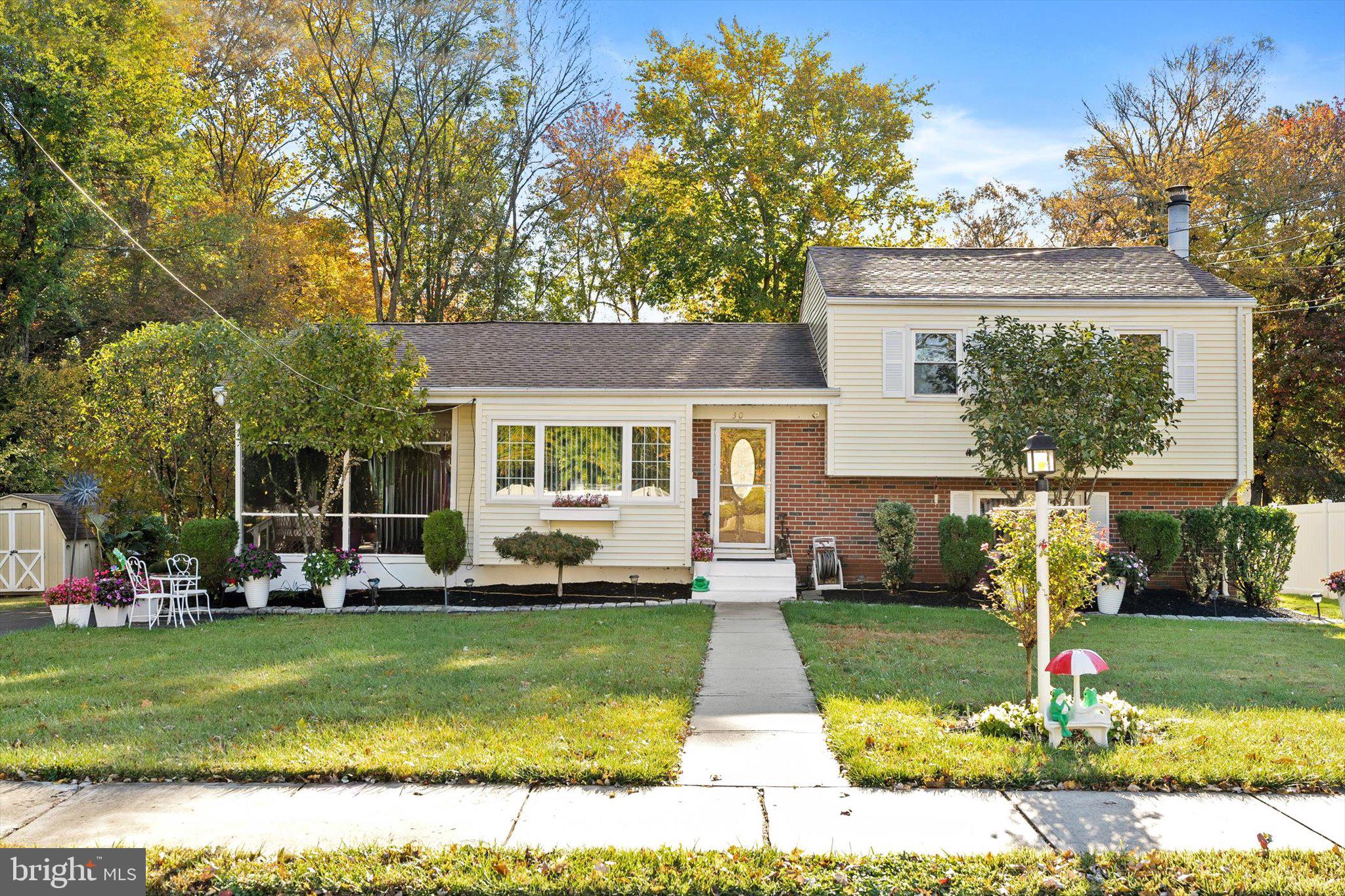 a front view of a house with a yard table and chairs