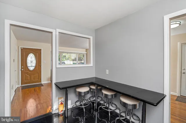 a view of a livingroom with wooden floor and a window