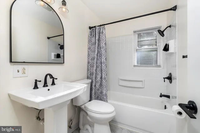 a living room with furniture a window and a flat screen tv
