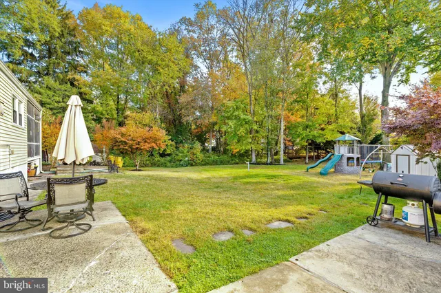 a swimming pool with trees in the background