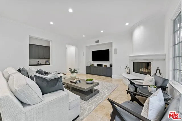 a kitchen with granite countertop white cabinets and stainless steel appliances
